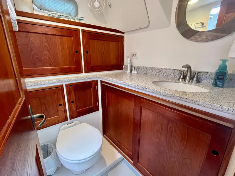 Slide: The Image of Cozy cabin interior of 2016 Wesmac 42 with wooden door and storage. - 50