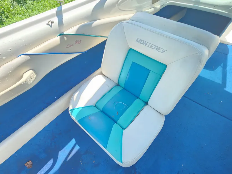 Slide: The Image of Interior of a 1997 Sea Ray 175 Five Series boat with blue and white seating. - 10