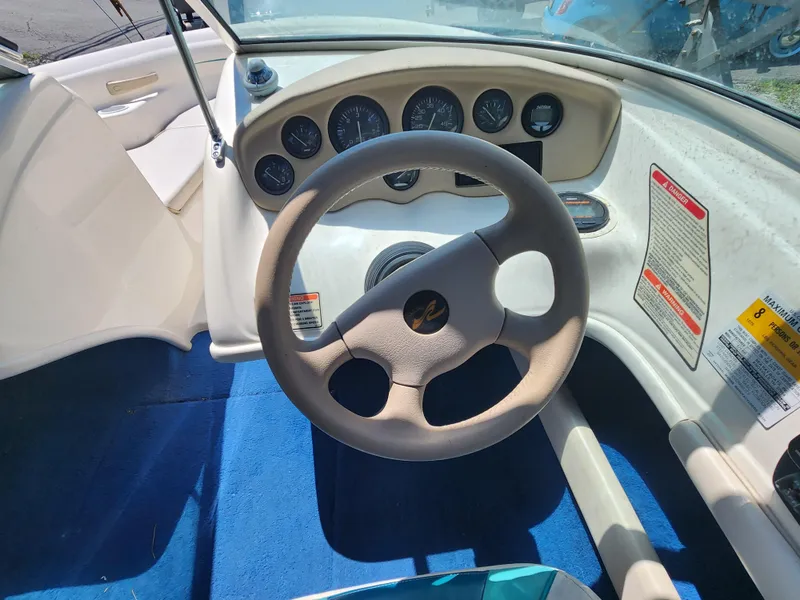 Slide: The Image of 1997 Sea Ray 175 Five Series boat dashboard with steering wheel and gauges. - 11