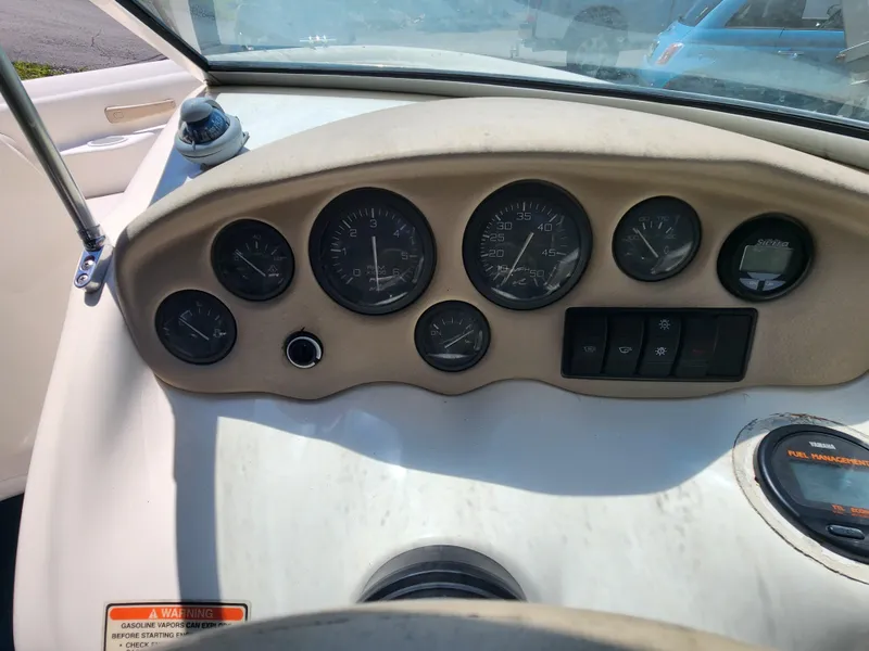 Slide: The Image of Dashboard of a 1997 Sea Ray 175 Five Series boat with gauges and controls. - 12