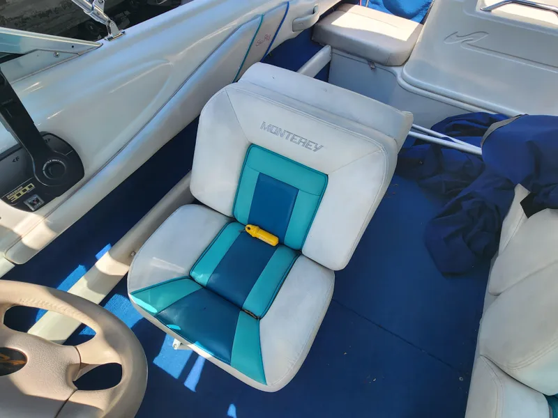 Slide: The Image of Interior of a 1997 Sea Ray 175 Five Series boat with blue and white seating. - 14