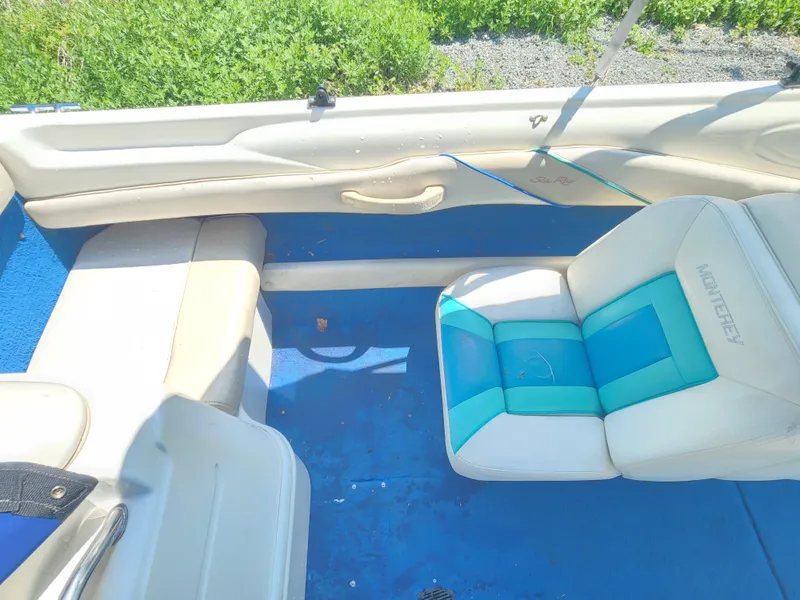 Slide: The Image of Interior of a 1997 Sea Ray 175 Five Series boat with blue and white seating. - 17