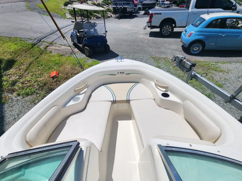 Slide: The Image of 1997 Sea Ray 175 Five Series boat interior with seating, parked near vehicles. - 20