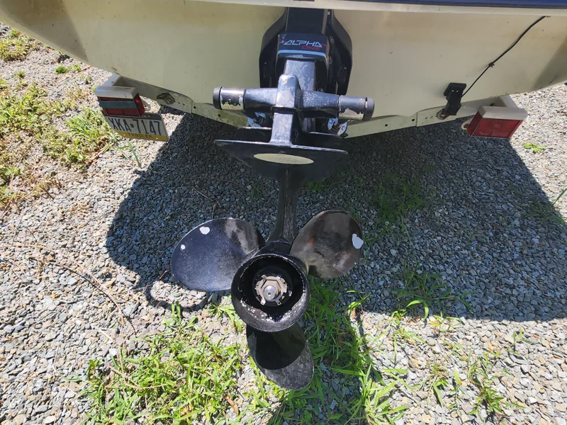 Slide: The Image of 1997 Sea Ray 175 Five Series boat propeller on gravel surface. - 22