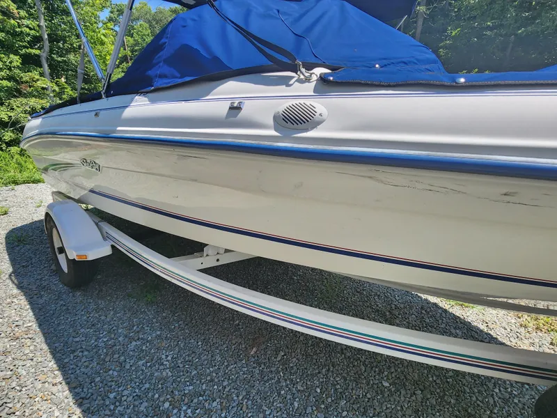 Slide: The Image of 1997 Sea Ray 175 Five Series boat with blue cover on trailer. - 3