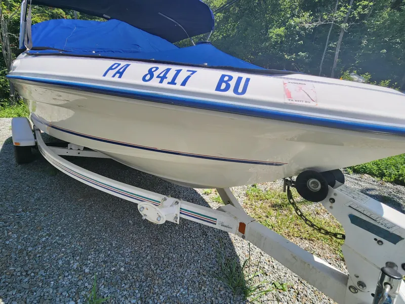 Slide: The Image of 1997 Sea Ray 175 Five Series boat on trailer, blue cover, parked on gravel. - 4