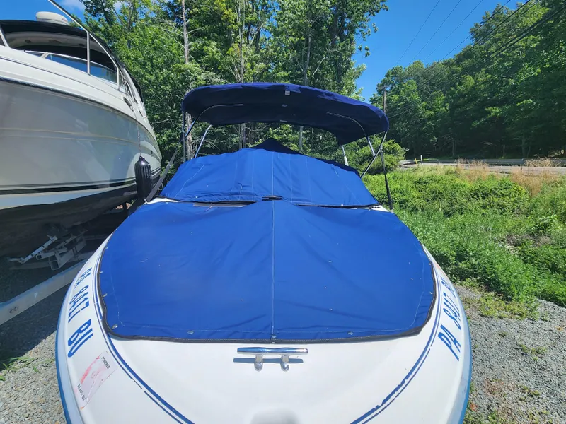 Slide: The Image of 1997 Sea Ray 175 Five Series boat with blue cover, parked outdoors. - 5