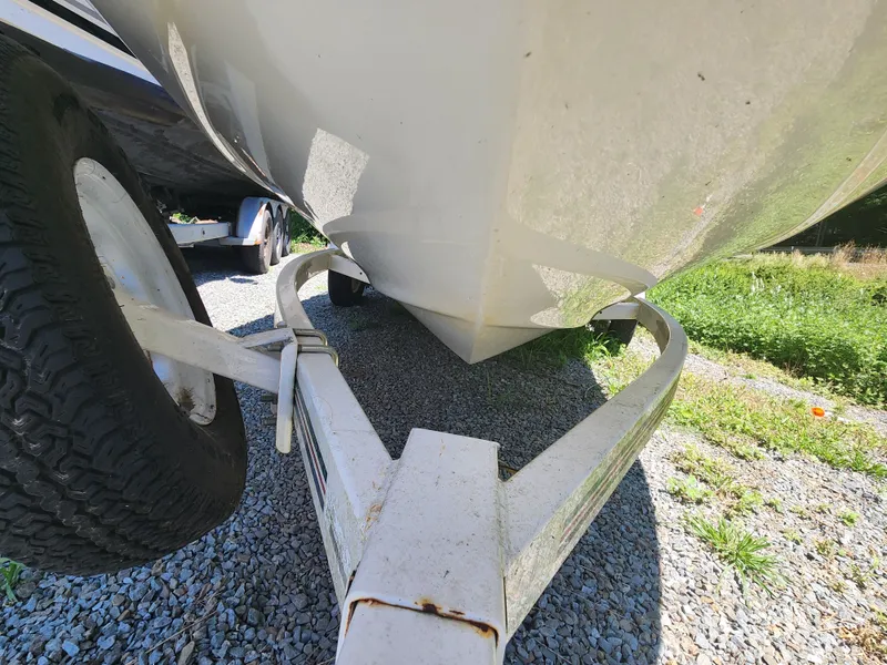 Slide: The Image of 1997 Sea Ray 175 Five Series boat on trailer, parked on gravel. - 7