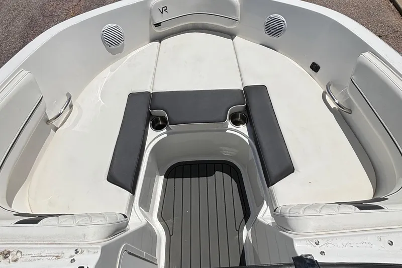 Slide: The Image of 2023 Bayliner VR5 boat interior with cushioned seating and cup holders. - 4
