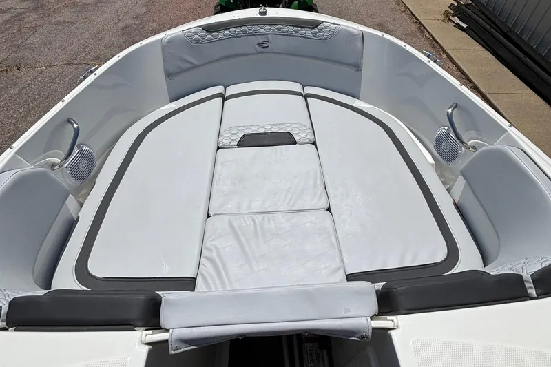 Slide: The Image of 2023 Bayliner E19 boat interior with cushioned seating and storage compartments. - 6