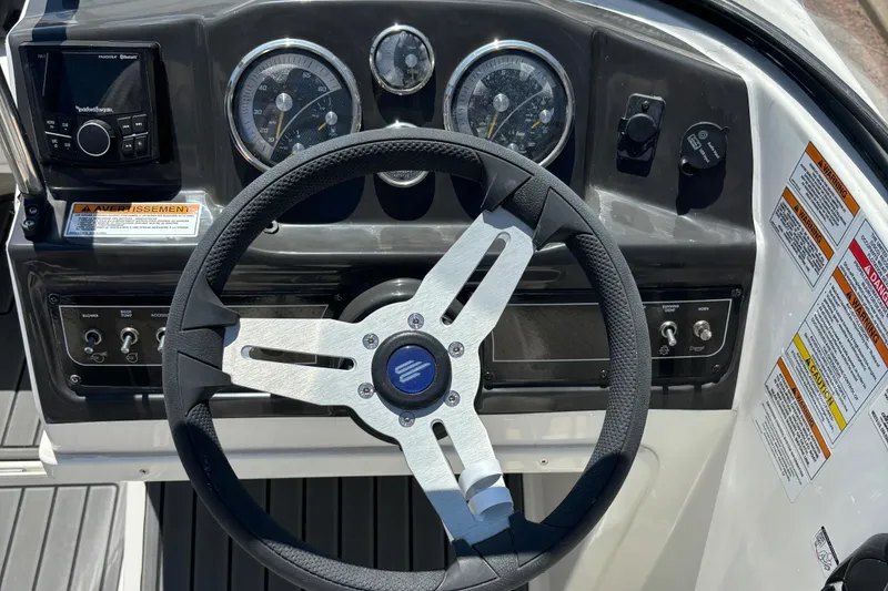 Slide: The Image of 2023 Bayliner VR4 boat dashboard with steering wheel and instrument panel. - 3