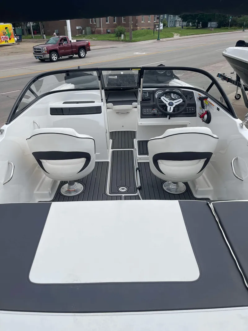 Slide: The Image of 2023 Bayliner VR4 boat interior with dual swivel seats and modern dashboard. - 2