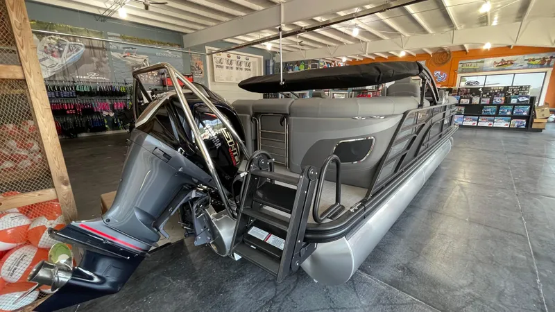 Slide: The Image of 2024 Bennington 23LFB pontoon boat with outboard motor in showroom. - 3