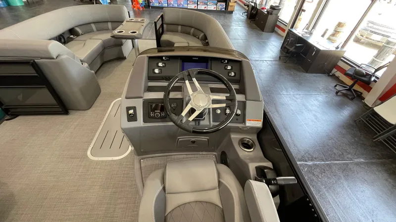 Slide: The Image of 2024 Bennington 23LFB boat interior with steering console and seating area. - 6