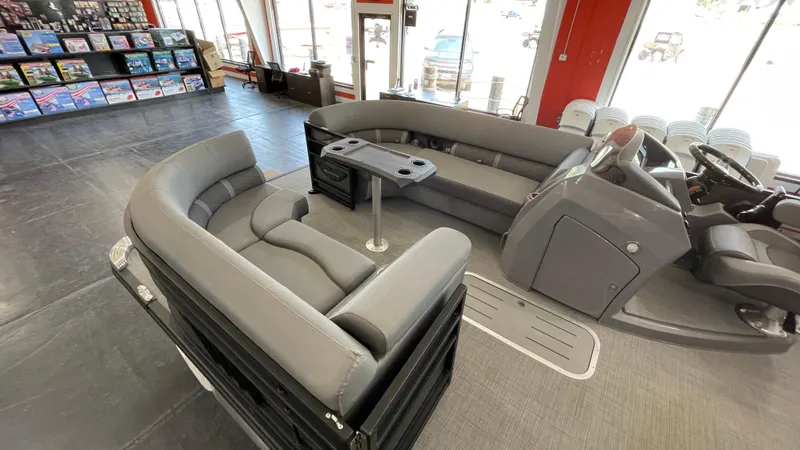 Slide: The Image of 2024 Bennington 23LFB pontoon boat interior with gray seating and helm station. - 8