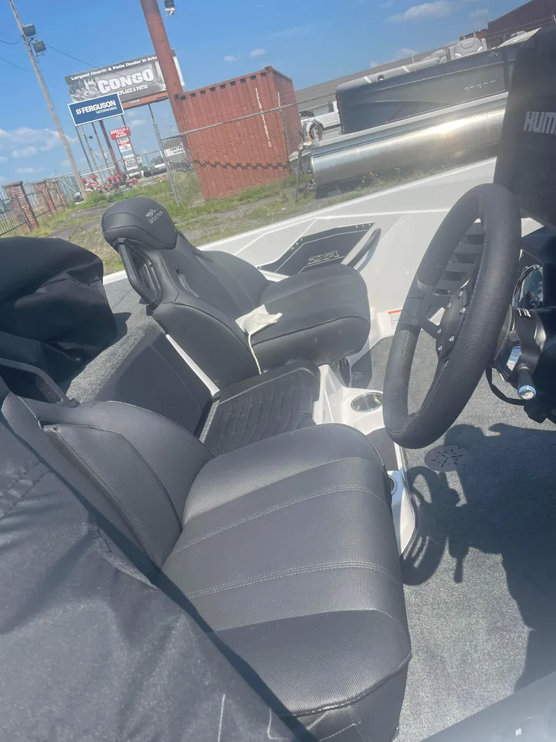 Slide: The Image of 2025 Skeeter ZXR 20 boat interior with black seats and steering wheel. - 10