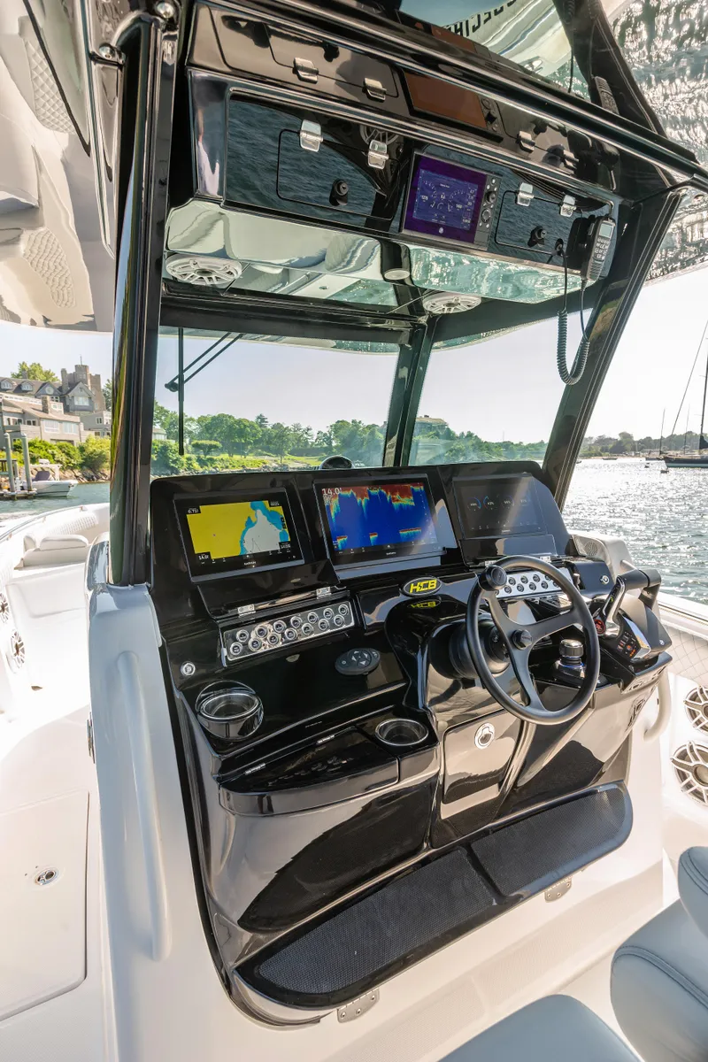 Slide: The Image of 2024 HCB 39 Speciale boat dashboard with advanced navigation systems and controls. - 14