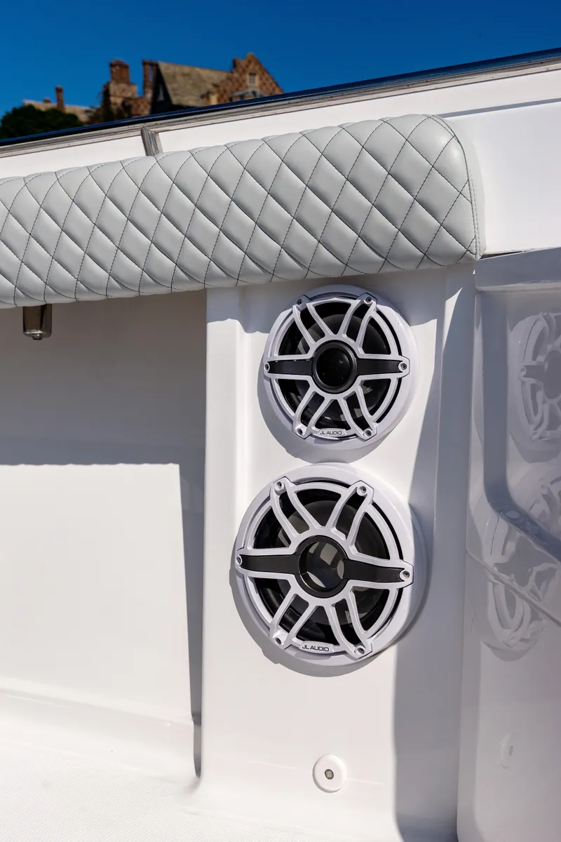 Slide: The Image of 2024 HCB 39 Speciale boat with dual marine speakers and quilted upholstery. - 17