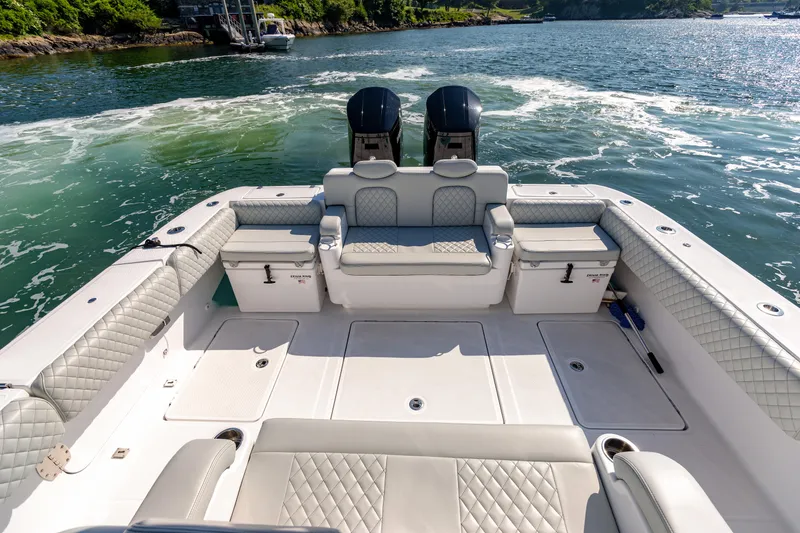 Slide: The Image of 2024 HCB 39 Speciale boat with luxurious seating and twin outboard engines on the water. - 22