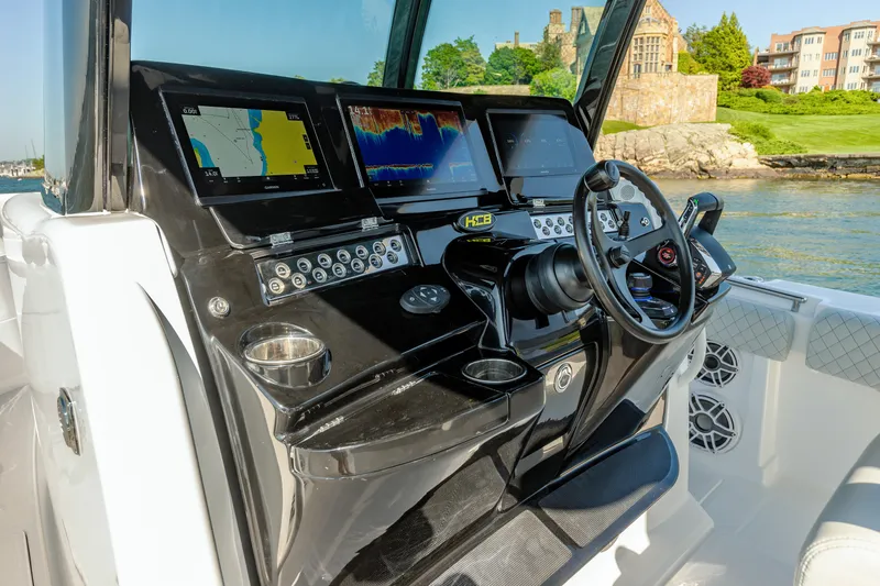 Slide: The Image of HCB 39 Speciale 2024 boat dashboard with navigation screens and steering wheel. - 29