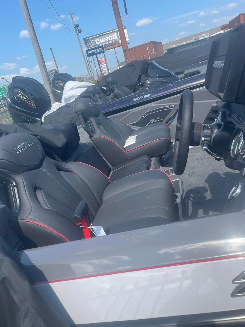 Slide: The Image of 2025 Skeeter ZXR21 boat interior with black and red seats. - 6