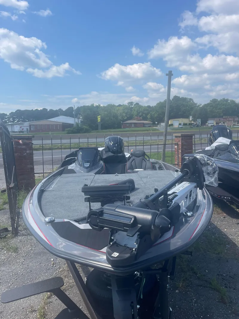 Slide: The Image of 2025 Skeeter ZXR21 bass boat on display outdoors. - 7