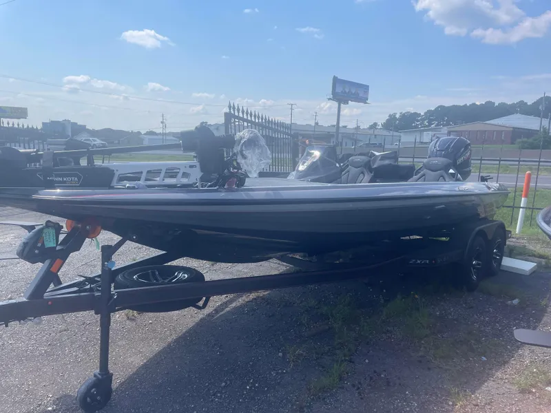 Slide: The Image of 2025 Skeeter ZXR21 fishing boat on a trailer in a parking lot. - 9