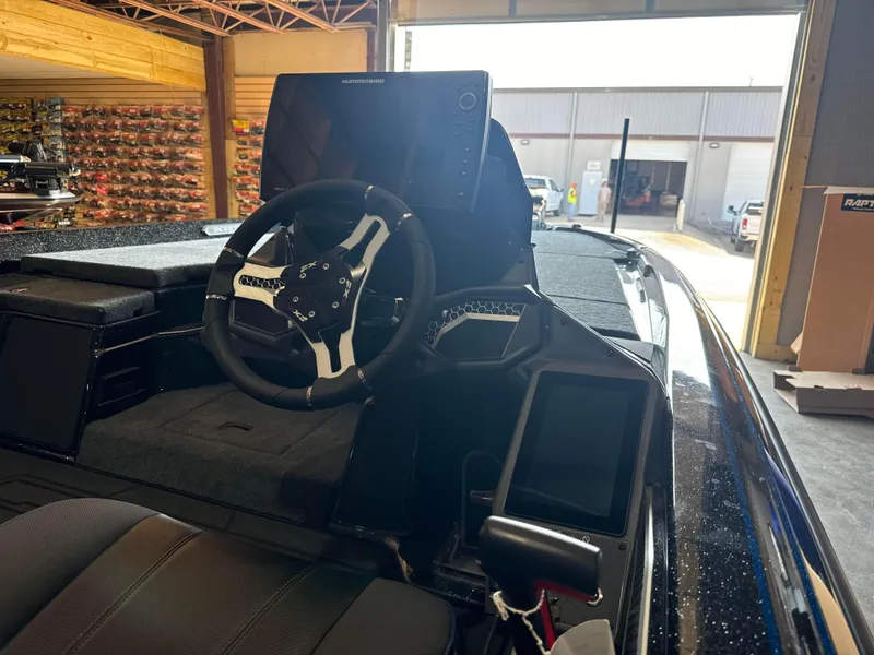 Slide: The Image of 2025 Skeeter FXRL21 boat interior with steering wheel and electronic displays. - 5