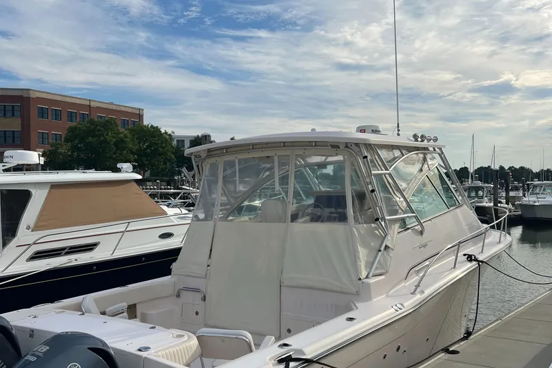 Slide: The Image of 2008 Grady-White Express 360 boat docked at a marina under a partly cloudy sky. - 4