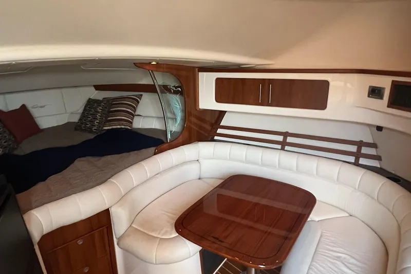 Slide: The Image of Interior cabin of 2008 Grady-White Express 360 with white seating and wooden table. - 6