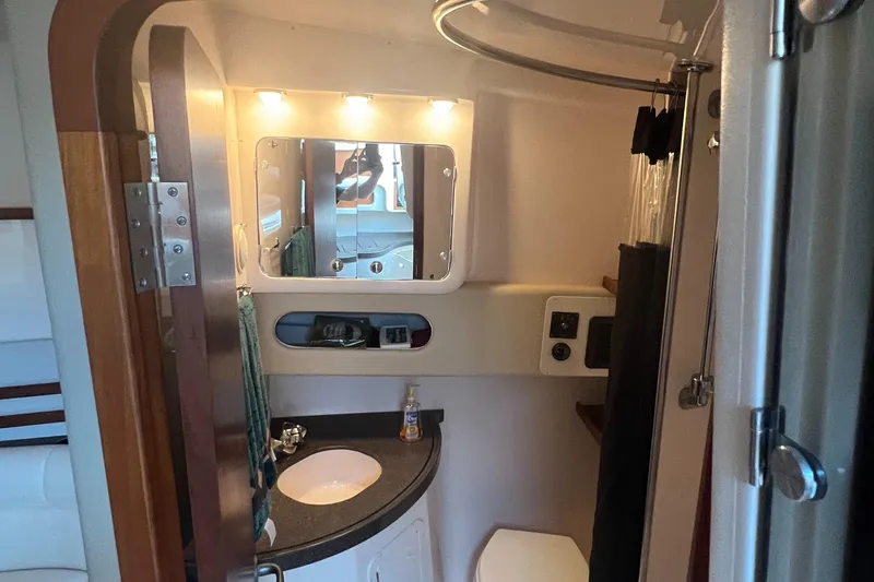 Slide: The Image of 2008 Grady-White Express 360 boat bathroom with sink, mirror, and toilet. - 8