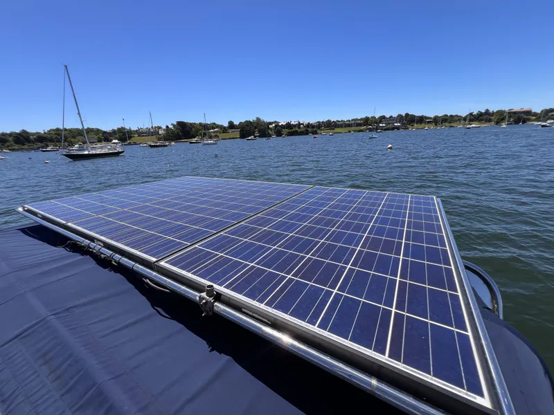 Slide: The Image of Solar panels on a 2012 Beneteau Sense 50 yacht, anchored in a serene bay. - 21