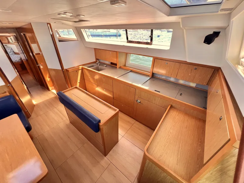 Slide: The Image of Interior of 2012 Beneteau Sense 50 yacht with modern kitchen and wooden cabinetry. - 3