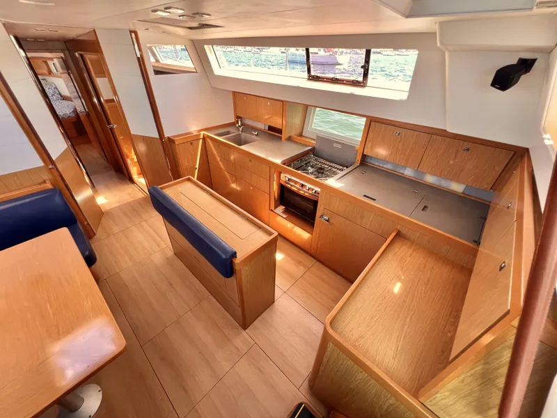 Slide: The Image of Interior of 2012 Beneteau Sense 50 yacht with modern kitchen and dining area. - 4