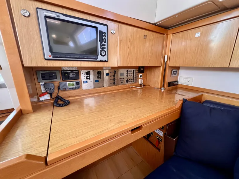 Slide: The Image of Navigation station of 2012 Beneteau Sense 50 yacht with control panels and display. - 5
