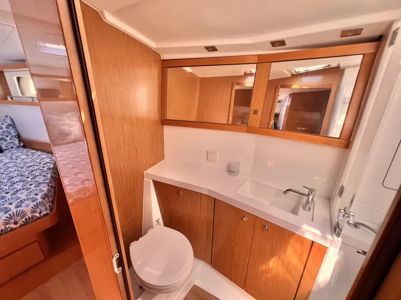 Slide: The Image of Modern bathroom in 2012 Beneteau Sense 50 yacht with wood cabinetry and white fixtures. - 9