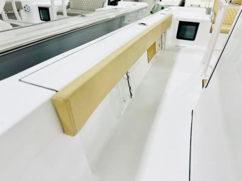 Slide: The Image of 2024 Sportsman MASTERS 247 BAY boat interior with cushioned seating and storage compartments. - 13