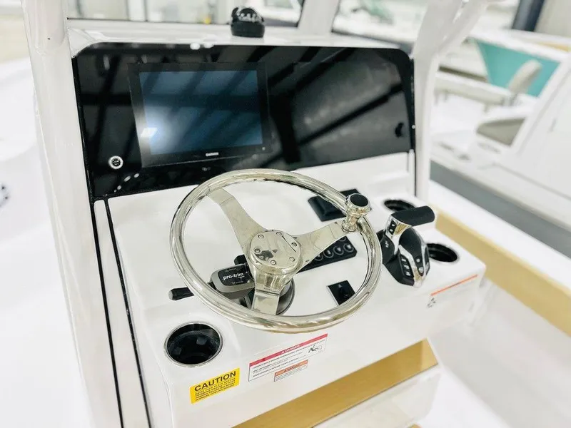 Slide: The Image of 2024 Sportsman MASTERS 247 BAY boat console with steering wheel and controls. - 2