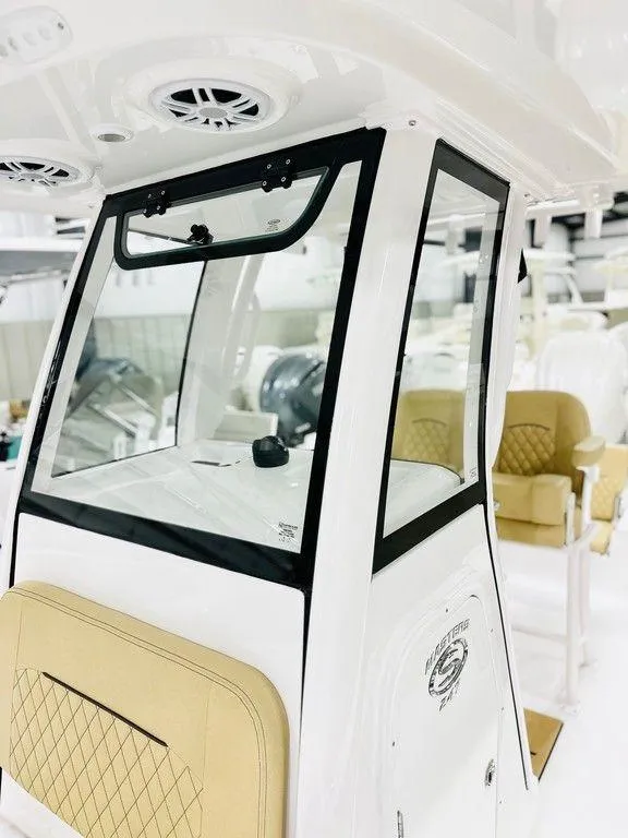 Slide: The Image of 2024 Sportsman MASTERS 247 BAY boat interior with beige seating and modern console. - 8