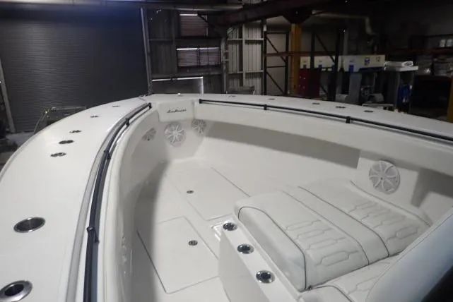 Slide: The Image of 2022 SeaHunter 35 Tournament boat interior with white seating and speakers. - 4