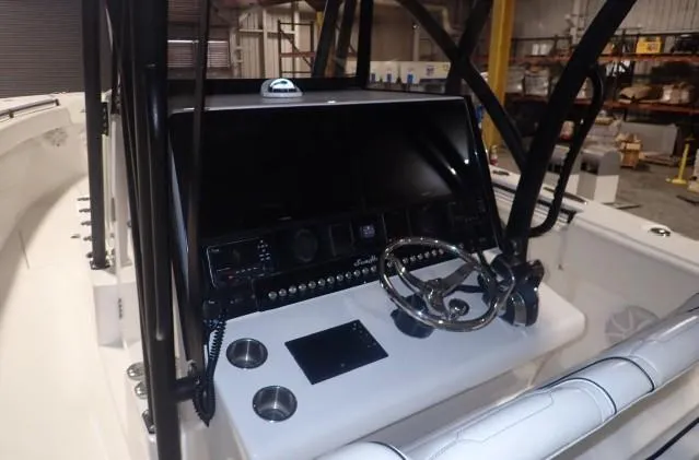 Slide: The Image of 2022 SeaHunter 35 Tournament boat console with steering wheel and electronic controls. - 6