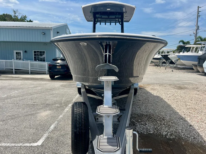 Slide: The Image of 2025 Robalo R250 boat on trailer in marina parking lot. - 2