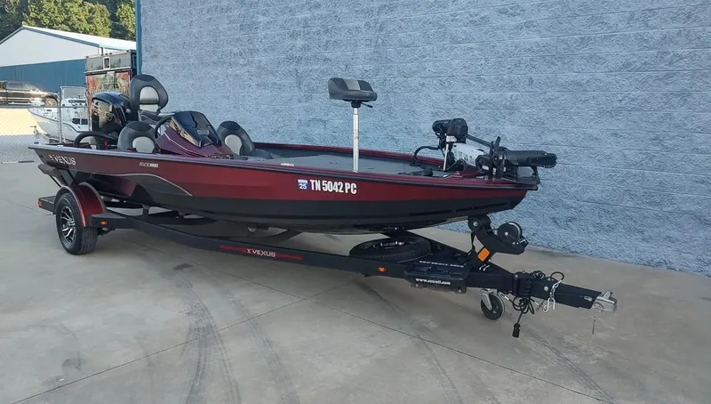 Slide: The Image of 2021 Vexus AVX1880 fishing boat on trailer, red and black, parked outside. - 11