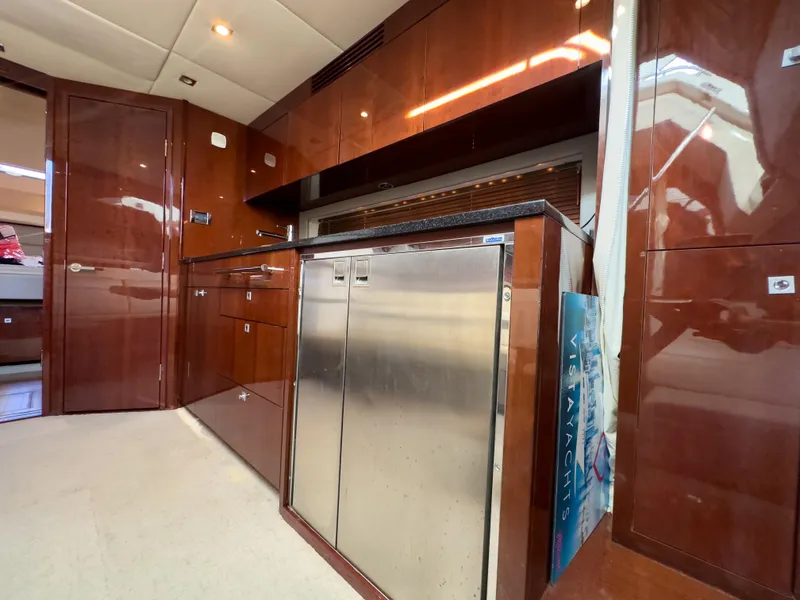 Slide: The Image of Interior of 2010 Sea Ray 450 Sundancer yacht with modern kitchen amenities. - 10