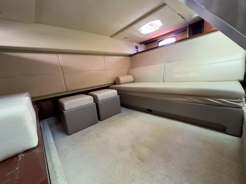 Slide: The Image of Interior cabin of 2010 Sea Ray 450 Sundancer yacht with beige seating and ottomans. - 13