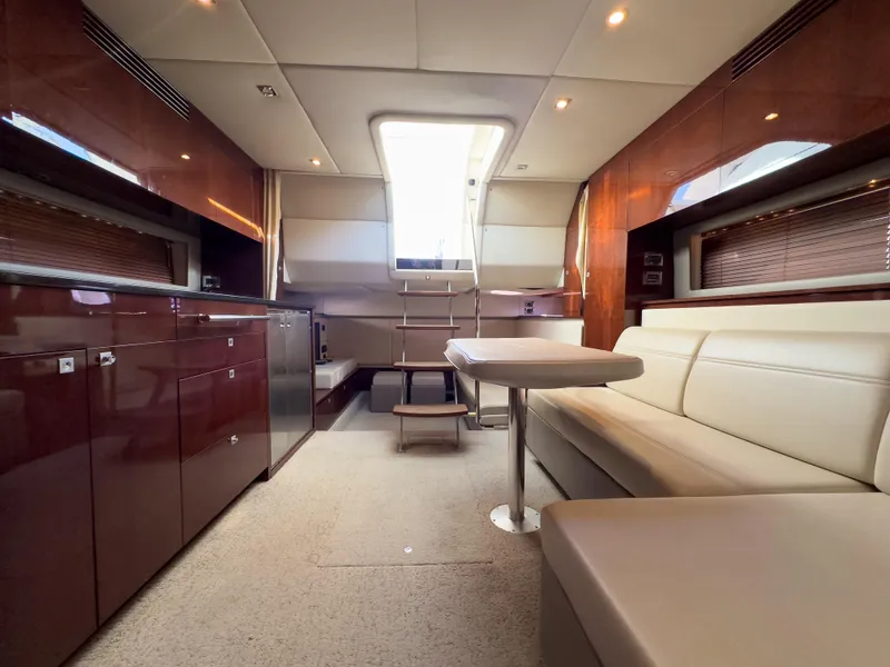 Slide: The Image of Luxurious interior of 2010 Sea Ray 450 Sundancer yacht with modern seating and cabinetry. - 14