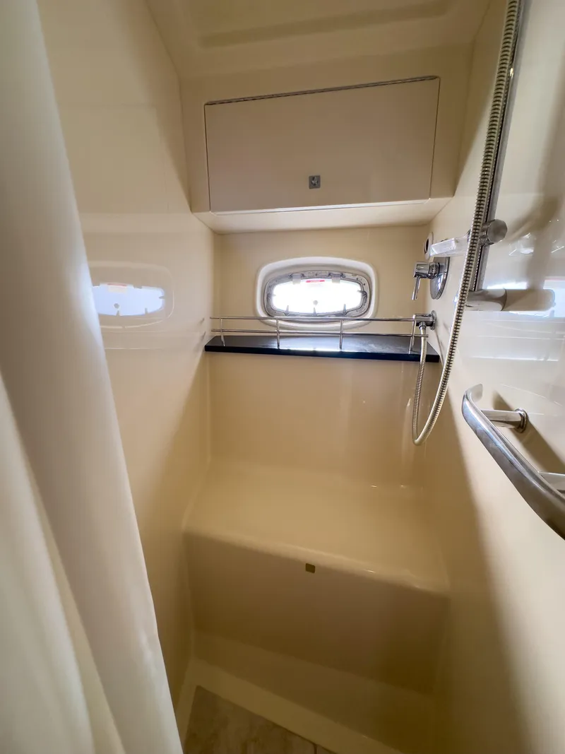 Slide: The Image of 2010 Sea Ray 450 Sundancer shower with window and built-in seat. - 15