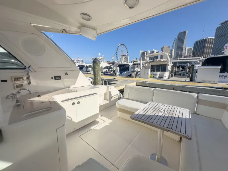 Slide: The Image of 2010 Sea Ray 450 Sundancer yacht interior with city skyline and Ferris wheel in the background. - 16