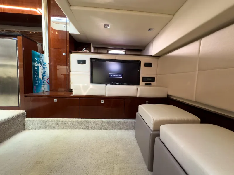 Slide: The Image of Luxurious interior of 2010 Sea Ray 450 Sundancer yacht with TV and seating area. - 17