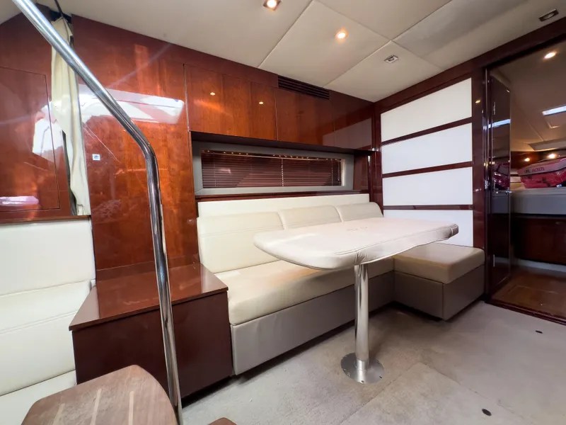 Slide: The Image of Interior of 2010 Sea Ray 450 Sundancer yacht with modern seating and dining area. - 18